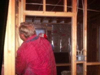 carpenter installing interior framing around a door